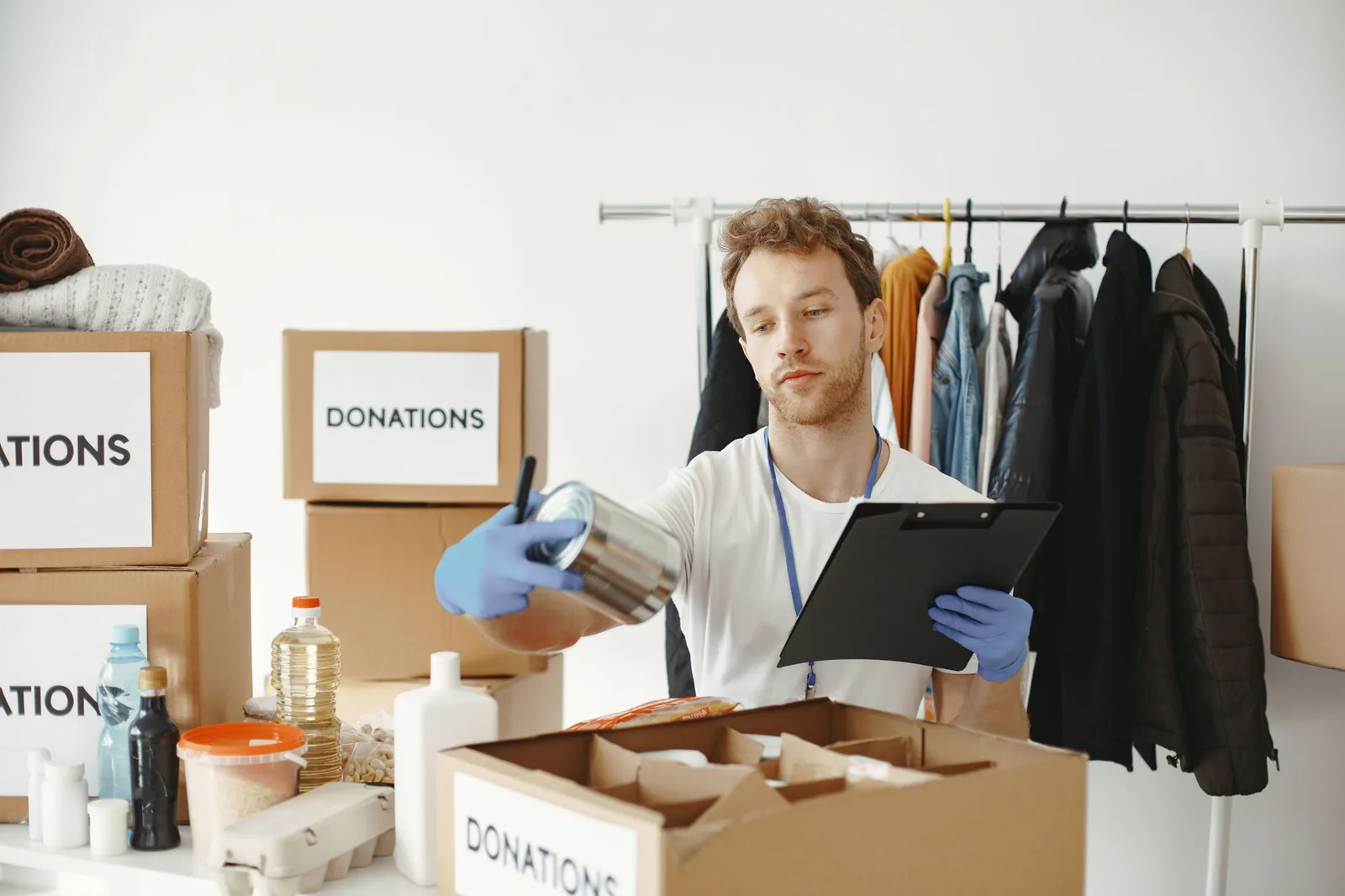 Volunteer organizing food donations at a community center