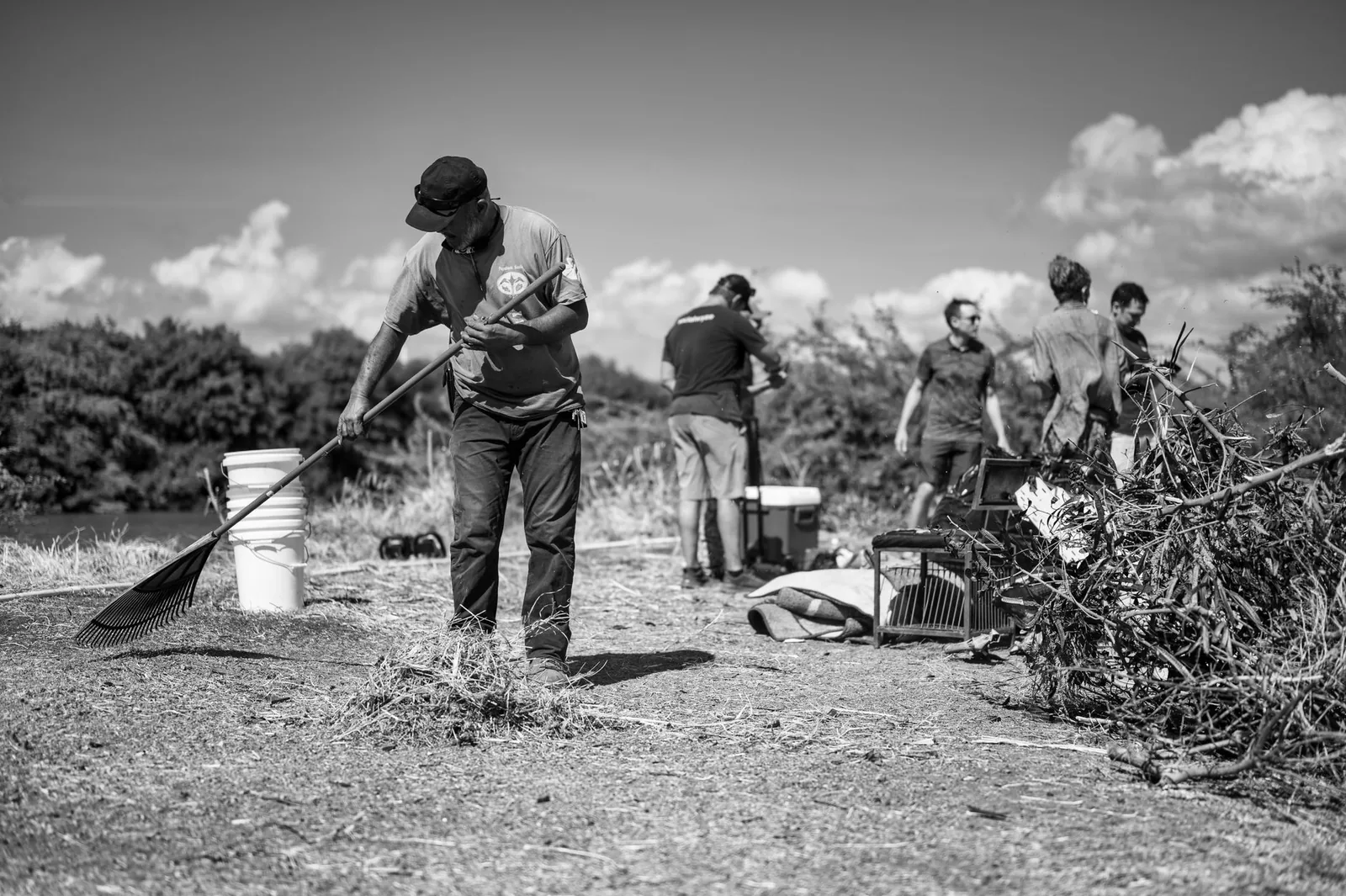 Volunteers cleaning up a riverbank as part of an environmental restoration project